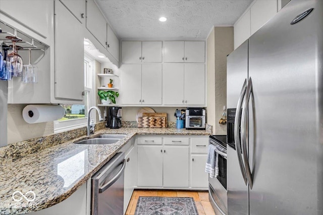 2204 Pamela Dr, Indianapolis, IN 46220 - kitchen with white cabinetry, stainless steel appliances, a textured ceiling, and a sink