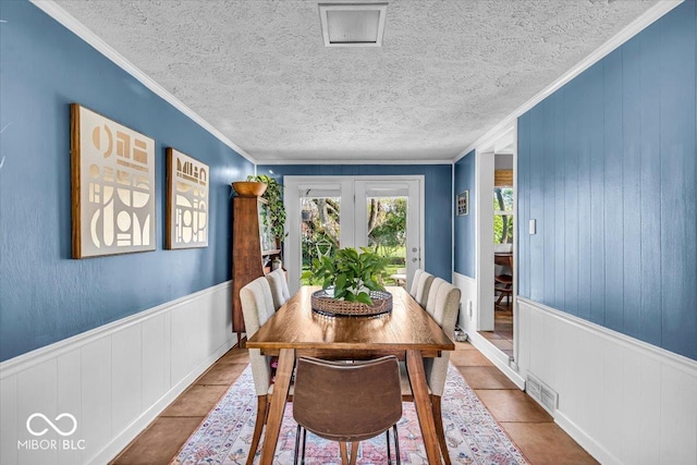 2204 Pamela Dr, Indianapolis, IN 46220 - dining area with crown molding, visible vents, a wainscoted wall, and a textured ceiling