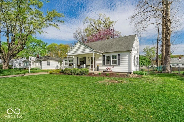 2204 Pamela Dr, Indianapolis, IN 46220 - view of front of home featuring a porch, a front lawn, fence, and a shingled roof
