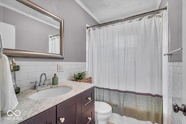 2204 Pamela Dr, Indianapolis, IN 46220 - full bath featuring a textured ceiling, vanity, tile walls, toilet, and ornamental molding