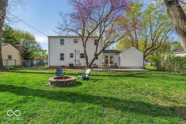 2204 Pamela Dr, Indianapolis, IN 46220 - back of property featuring fence, a yard, a patio area, french doors, and an outdoor fire pit