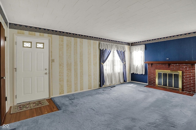 1194 S Faculty Dr, Indianapolis, IN 46241 - unfurnished living room featuring baseboards, carpet, a brick fireplace, and wallpapered walls