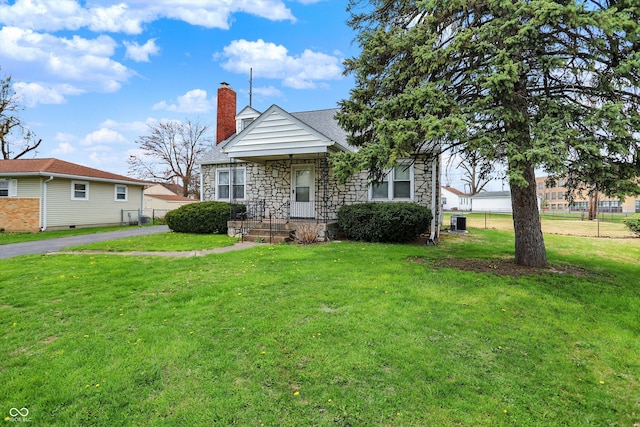1194 S Faculty Dr, Indianapolis, IN 46241 - bungalow-style home featuring a front yard, stone siding, a chimney, and a shingled roof