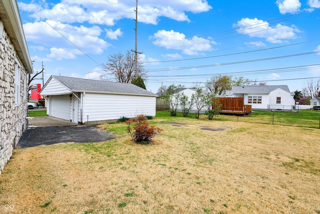 1194 S Faculty Dr, Indianapolis, IN 46241 - view of yard with aphalt driveway, a detached garage, fence, and an outdoor structure