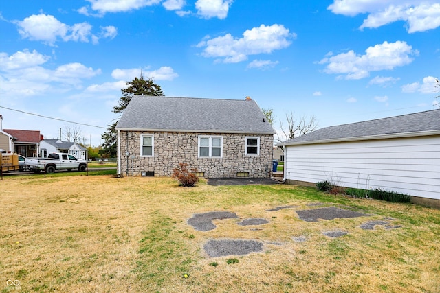 1194 S Faculty Dr, Indianapolis, IN 46241 - rear view of property with roof with shingles, stone siding, and a lawn