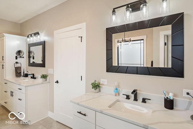 bathroom featuring two vanities, a sink, and tile patterned flooring