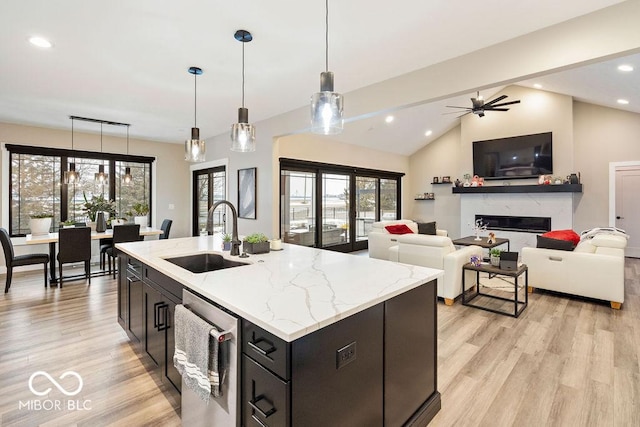kitchen featuring recessed lighting, light wood finished floors, a sink, and a healthy amount of sunlight