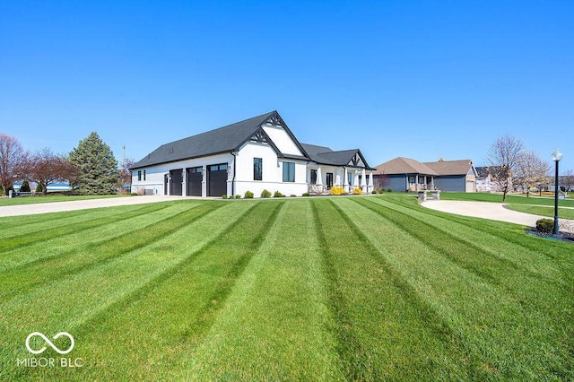 back of house with a yard and a garage