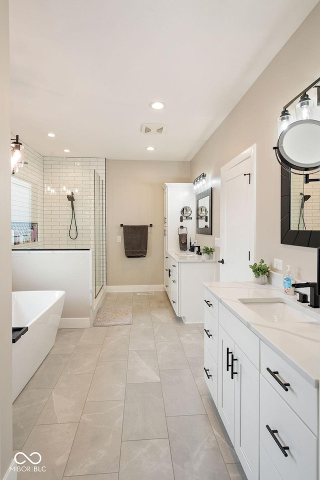 bathroom with a freestanding tub, visible vents, recessed lighting, a sink, and a stall shower