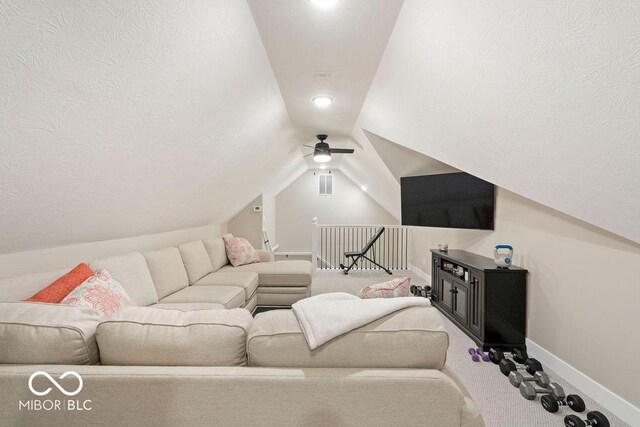 carpeted living area with ceiling fan, baseboards, lofted ceiling, and visible vents
