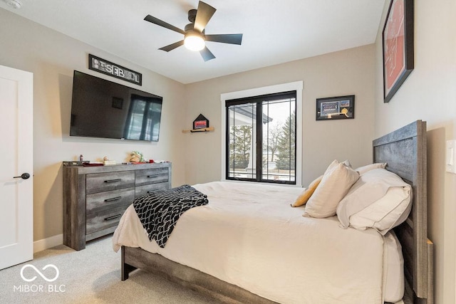 bedroom featuring ceiling fan, light colored carpet, and baseboards