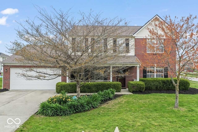 5817 Thompson Park Blvd, Indianapolis, IN 46237 - view of front facade with driveway, a front yard, a garage, and brick siding