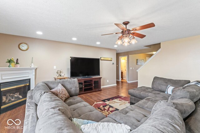 5817 Thompson Park Blvd, Indianapolis, IN 46237 - living room with ceiling fan, a glass covered fireplace, recessed lighting, wood finished floors, and baseboards