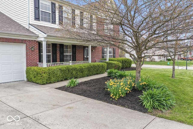 5817 Thompson Park Blvd, Indianapolis, IN 46237 - view of front of house with brick siding, a front yard, a porch, and roof with shingles
