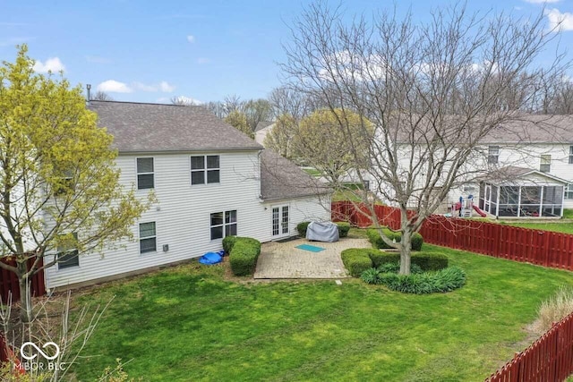 5817 Thompson Park Blvd, Indianapolis, IN 46237 - back of property featuring a patio, a shingled roof, a fenced backyard, and a lawn