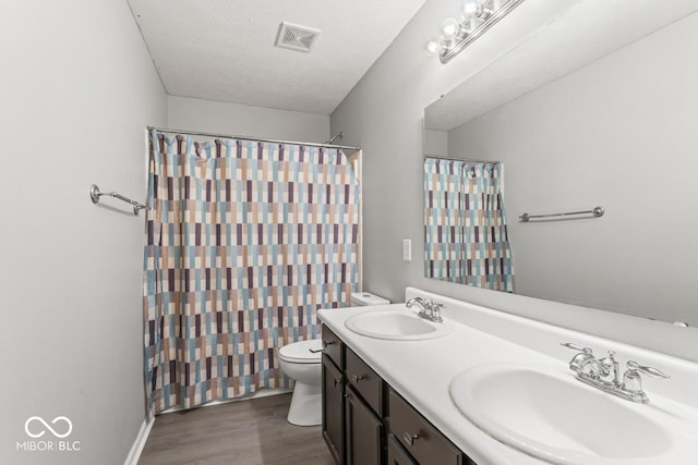 5817 Thompson Park Blvd, Indianapolis, IN 46237 - full bath with a sink, visible vents, toilet, and wood finished floors