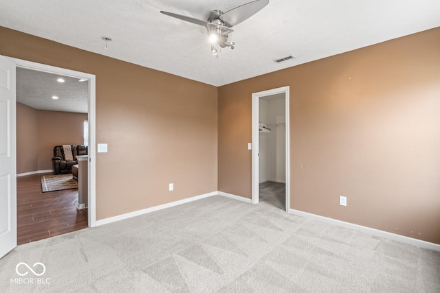 5817 Thompson Park Blvd, Indianapolis, IN 46237 - unfurnished bedroom with visible vents, baseboards, ceiling fan, carpet, and a walk in closet