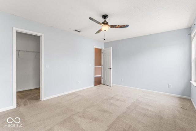 5817 Thompson Park Blvd, Indianapolis, IN 46237 - unfurnished bedroom featuring ceiling fan, a closet, a spacious closet, light carpet, and baseboards