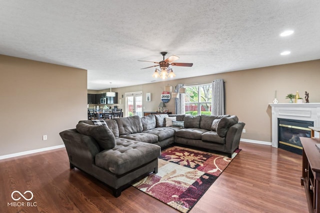 5817 Thompson Park Blvd, Indianapolis, IN 46237 - living area with a textured ceiling, wood finished floors, ceiling fan, and baseboards