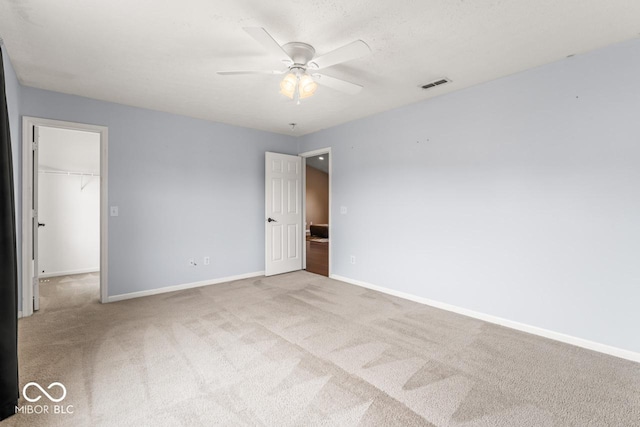 5817 Thompson Park Blvd, Indianapolis, IN 46237 - unfurnished bedroom with visible vents, baseboards, a walk in closet, and carpet floors