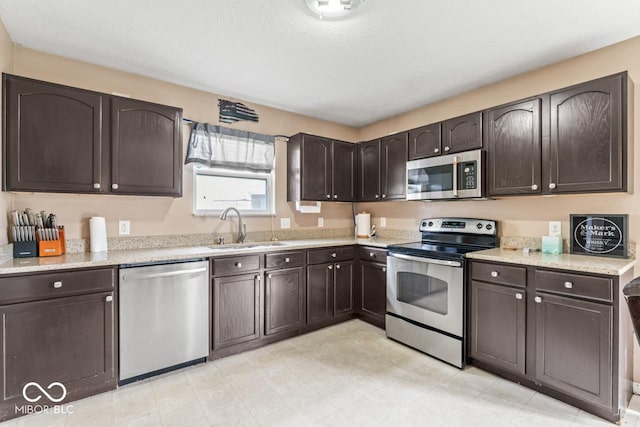 5817 Thompson Park Blvd, Indianapolis, IN 46237 - kitchen featuring a sink, dark brown cabinets, and stainless steel appliances