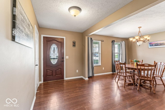 5817 Thompson Park Blvd, Indianapolis, IN 46237 - entrance foyer featuring a textured ceiling, wood finished floors, a notable chandelier, and baseboards