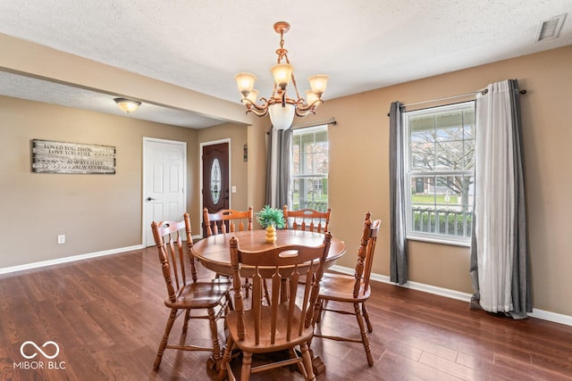 5817 Thompson Park Blvd, Indianapolis, IN 46237 - dining space featuring baseboards, a chandelier, a textured ceiling, dark wood-type flooring, and visible vents