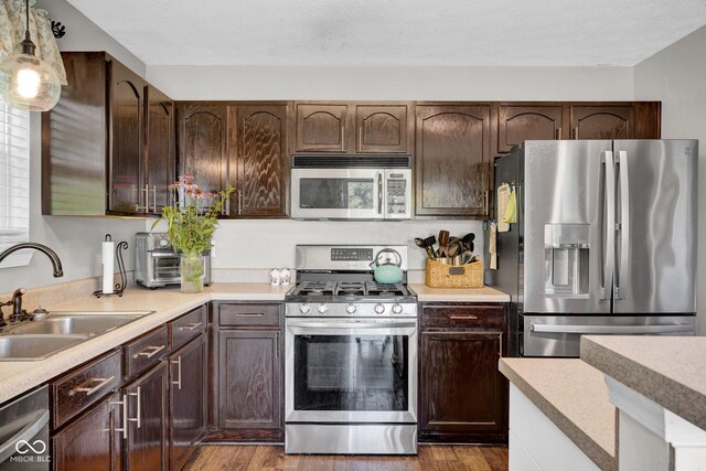 1280 Summer Ridge Ln, Brownsburg, IN 46112 - kitchen with stainless steel appliances, light countertops, and wood finished floors