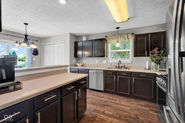 1280 Summer Ridge Ln, Brownsburg, IN 46112 - kitchen featuring appliances with stainless steel finishes, a textured ceiling, plenty of natural light, light countertops, and a chandelier