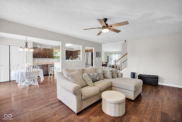 1280 Summer Ridge Ln, Brownsburg, IN 46112 - living room with ceiling fan, dark wood-style floors, stairs, a textured ceiling, and a chandelier