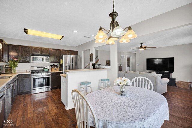 1280 Summer Ridge Ln, Brownsburg, IN 46112 - dining area with a chandelier, ceiling fan, dark wood-style floors, and recessed lighting