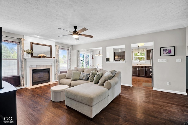 1280 Summer Ridge Ln, Brownsburg, IN 46112 - living area featuring ceiling fan, dark wood finished floors, a fireplace, and a textured ceiling