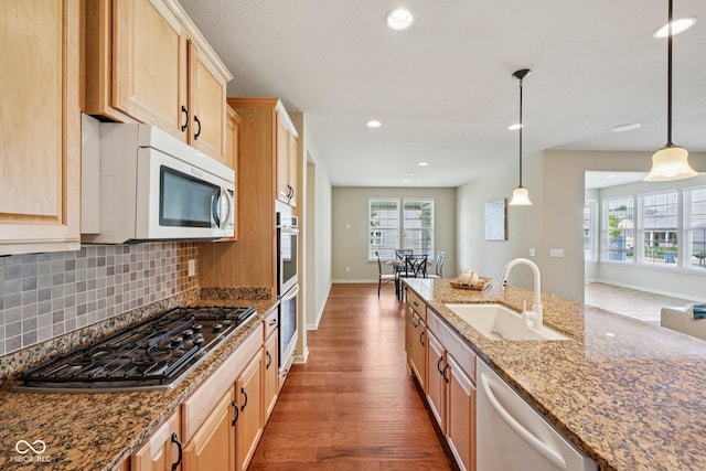 12907 Shiraz Ln, Fishers, IN 46037 - kitchen featuring appliances with stainless steel finishes, a sink, wood finished floors, baseboards, and healthy amount of natural light