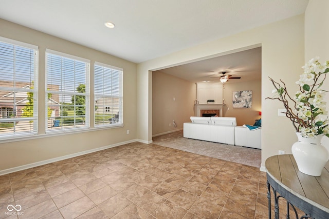 12907 Shiraz Ln, Fishers, IN 46037 - living area with plenty of natural light, a fireplace, a ceiling fan, baseboards, and recessed lighting