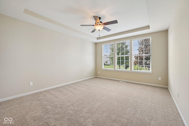12907 Shiraz Ln, Fishers, IN 46037 - unfurnished room featuring light carpet, a raised ceiling, ceiling fan, and baseboards