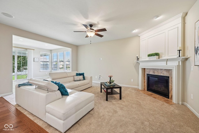 12907 Shiraz Ln, Fishers, IN 46037 - living area with a ceiling fan, a tile fireplace, baseboards, light carpet, and recessed lighting