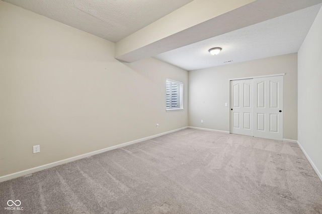 12907 Shiraz Ln, Fishers, IN 46037 - unfurnished bedroom featuring light carpet, baseboards, a closet, and a textured ceiling