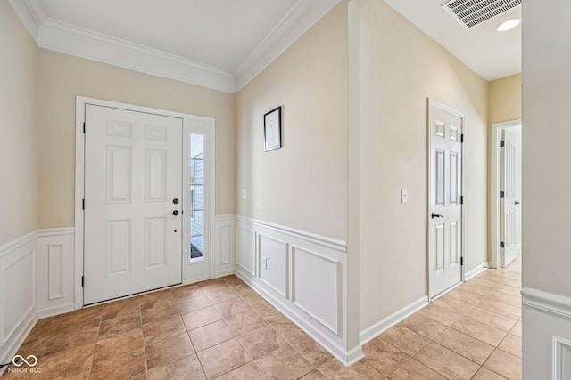 12907 Shiraz Ln, Fishers, IN 46037 - foyer with wainscoting, a decorative wall, crown molding, and light tile patterned floors