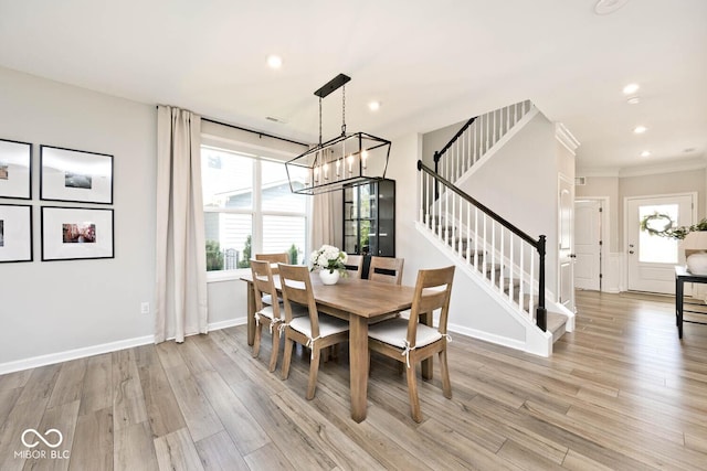 dining room with recessed lighting, light wood-style floors, crown molding, a chandelier, and stairs