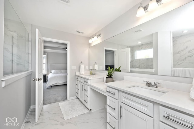ensuite bathroom featuring a marble finish shower, vanity, marble finish floor, baseboards, and visible vents