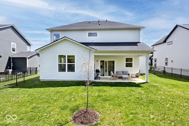 back of property with an outdoor living space, a lawn, a fenced backyard, and a patio
