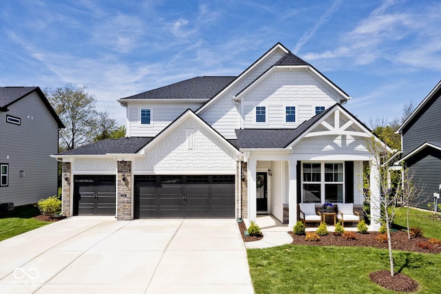 view of front of house with a front lawn, an attached garage, driveway, covered porch, and roof with shingles