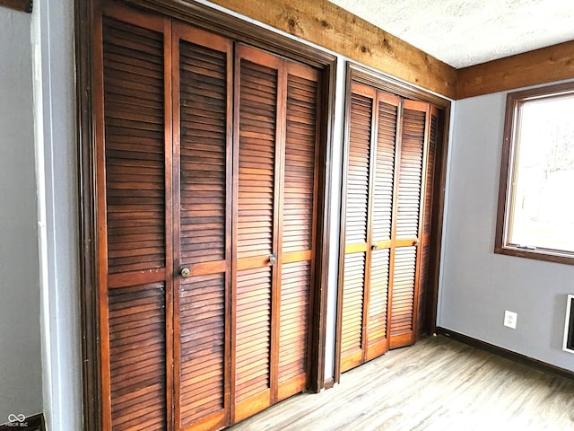 interior details featuring wood finished floors and baseboards