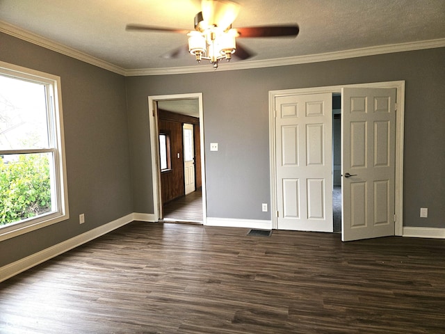 interior space featuring dark wood-type flooring, a healthy amount of sunlight, baseboards, and a ceiling fan