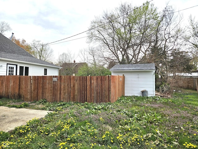 view of yard with fence private yard and an outdoor structure