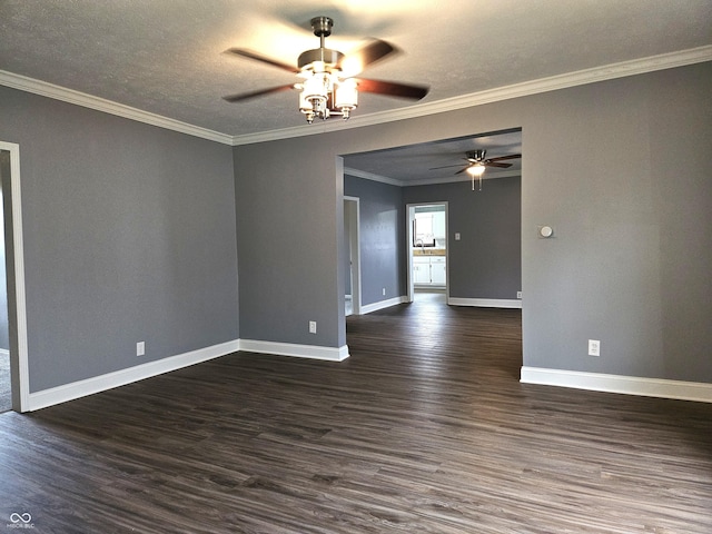 unfurnished room featuring ornamental molding, dark wood-style flooring, baseboards, and a ceiling fan