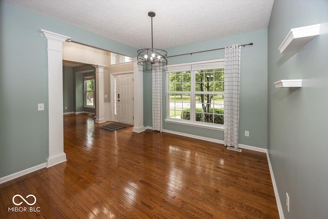 11648 Stickney Ct, Fishers, IN 46037 - foyer with decorative columns, baseboards, wood finished floors, and a textured ceiling