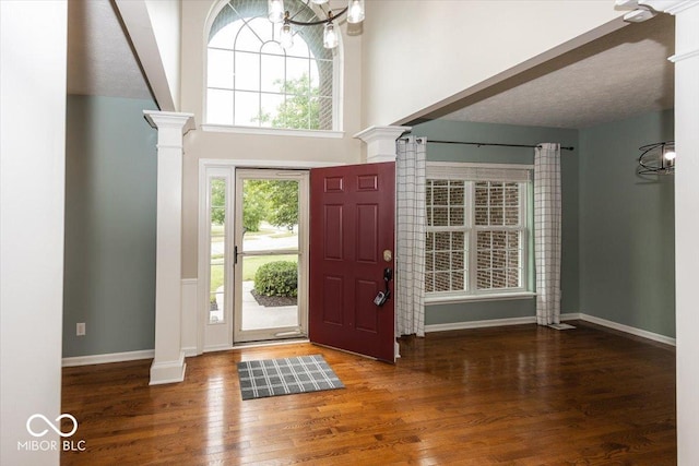 11648 Stickney Ct, Fishers, IN 46037 - foyer with decorative columns, wood finished floors, and a chandelier