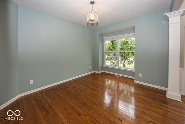 11648 Stickney Ct, Fishers, IN 46037 - empty room featuring a chandelier, wood finished floors, baseboards, and a textured ceiling
