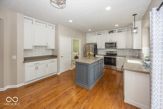 11648 Stickney Ct, Fishers, IN 46037 - kitchen featuring stainless steel appliances, white cabinets, backsplash, a sink, and recessed lighting